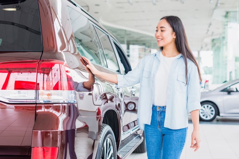 asian woman checking used car